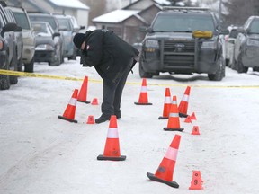 Calgary Police Crime Scene Unit member documents the scene on Somerside Close SW in Calgary on Sunday, January 12, 2020. At approximately 3:15 a.m., police received multiple calls of shots fired at the 100 block of Somerside Close S.W. and police found a home had been damaged by gunfire. There were no injuries. According to police, suspects had fled the scene. Jim Wells/Postmedia