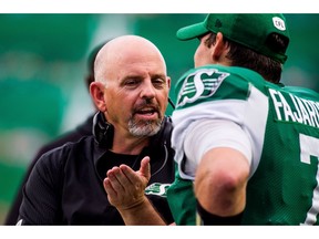 CP-Web.  Saskatchewan Roughriders head coach Craig Dickenson talks with Saskatchewan Roughriders quarterback Cody Fajardo (7) during second half CFL action against the Ottawa Redblacks, in Regina, Saturday, Aug. 24, 2019.