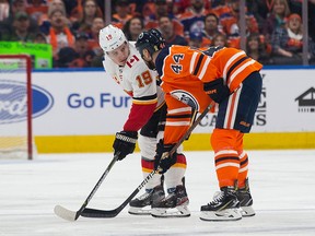 Oilers forward Zack Kassian has a discussion with Flames star Matthew Tkachuk at Rogers Place on Jan. 29 in Edmonton. File photo by Codie McLachlan/Getty Images.