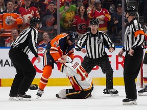 Oilers Zack Kassian and Flames Matthew Tkachuk fight in the first period at Rogers Place on Jan. 29, 2020.