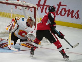 Flames goalie David Rittich makes a save on a shot by Ottawa Senators Brady Tkatchuk at the Canadian Tire Centre on Jan. 18, 2020.