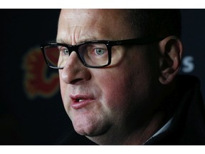 Calgary Flames General Manager Brad Treliving addresses the media following an NHL hockey practice Tuesday, Nov. 26, 2019, in Buffalo, N.Y. Treliving says Flames coach Bill Peters remains on the staff but wasnÕt certain whether heÕd be behind the bench for the next game. The team and the NHL are both investigating an allegation the Peters directed racial slurs at a player 10 years ago when the two were in the minors. Akim Aliu, a Nigerian-born player, says Peters Òdropped the N bomb several timesÓ in a dressing room during his rookie year.(AP Photo/Jeffrey T. Barnes) ORG XMIT: NYJB107