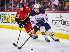 Flames defenceman Noah Hanifin chases Oilers Gaetan Haas during a preseason game at Scotiabank Saddledome last September.