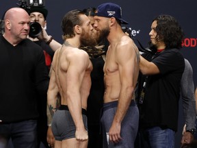 Welterweight fighters Conor McGregor, left, and Donald Cerrone face off during a ceremonial weigh-in for UFC 246 at Park Theater at Park MGM on Jan. 17, 2020 in Las Vegas, Nevada.  (Steve Marcus/Getty Images)