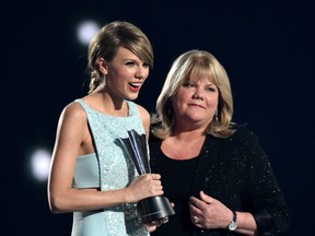 Honoree Taylor Swift, left, accepts the Milestone Award from Andrea Swift onstage during the 50th Academy Of Country Music Awards at AT&T Stadium on April 19, 2015 in Arlington, Texas. (Cooper Neill/Getty Images for dcp)