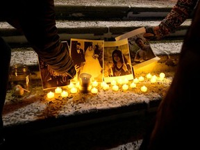 People attend a candlelight vigil held at the Edmonton Legislature building in memory of the victims of the Ukrainian passenger plane that crashed in Iran.