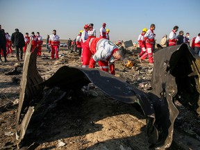Red Crescent workers check the debris from the Ukraine International Airlines plane that crashed after take-off from Iran's Imam Khomeini airport, on the outskirts of Tehran, Iran January 8, 2020. (Nazanin Tabatabaee/West Asia News Agency)