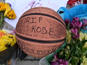 A basketball with a message to Kobe Bryant is seen at a memorial outside Bryant Gymnasium at Lower Merion High School, where Bryant formally attended school.