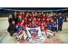 Calgary Buffaloes pose for a team photo after winning the Mac's AAA Hockey Tournament beating the Moose Jaw Warriors 6-2 at the Scotiabank Saddledome on New Year's Day in Calgary. Al Charest / Postmedia