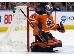 The Edmonton Oilers' goalie Mike Smith (41) makes a glove save against the Calgary Flames during second period NHL action at Rogers Place, in Edmonton Wednesday Jan. 29, 2020. Photo by David Bloom