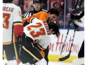 The Edmonton Oilers' Ryan Nugent-Hopkins (93) fights the Calgary Flames' Sean Monahan (23) during first period NHL action at Rogers Place, in Edmonton Wednesday Jan. 29, 2020. Photo by David Bloom