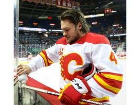 Calgary Flames Rasmus Andersson with a little bit of last-minute preparation to his stick  by adding a little bit of talcum powder during NHL hockey in Calgary on Thursday December 19, 2019. Al Charest / Postmedia