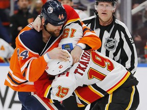 Oilers Zack Kassian and Flames Matthew Tkachuk fight during the first period at Rogers Place on Wednesday, Jan. 29, 2020.
