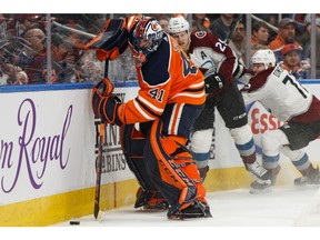 Edmonton Oilers goaltender Mike Smith battles Colorado Avalanche star forward Nathan MacKinnon during a recent game at Rogers Place in Edmonton. File photo by Ian Kucerak/Postmedia.