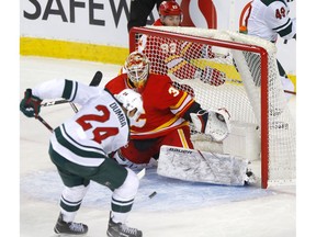 Flames goalie Cam Talbot stops Minnesota Wild sniper Matt Dumba from in close during Thursday night's game at the Scotiabank Saddledome. The Flames won 2-1. Photo by Darren Makowichuk/Postmedia.