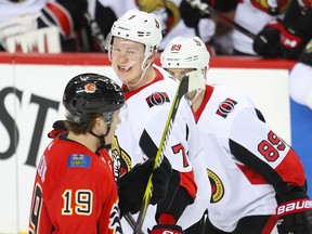 Ottawa Senators Brady Tkachuk skates by brother Matthew Tkachuk of the Calgary Flames during NHL hockey at the Scotiabank Saddledome in Calgary on Thursday, March 21, 2019. Al Charest/Postmedia