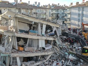 Rescue workers work at the scene of a collapsed building on Jan. 26, 2020, in Elazig, Turkey.