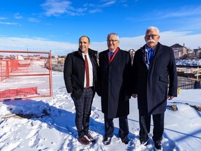 From left; Truman Homes vice-president Oliver Trutina, Minister of Transport Marc Garneau, and Truman Homes president George Trutina pose for a photo on Tuesday, Feb. 11, 2020 at the site of Mulberry, a five-storey 96-unit rental building being developed by Truman Homes.