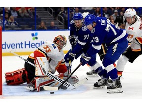 TAMPA, FLORIDA - FEBRUARY 12: David Rittich #33 of the Calgary Flames stops a shot from Adam Erne #73 of the Tampa Bay Lightning during a game  at Amalie Arena on February 12, 2019 in Tampa, Florida.