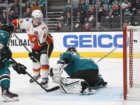 SAN JOSE, CALIFORNIA - FEBRUARY 10: Matthew Tkachuk #19 of the Calgary Flames scores a goal getting his shot past goalie Aaron Dell #30 of the San Jose Sharks during the third period of an NHL hockey game at SAP Center on February 10, 2020 in San Jose, California. The Flames won the game 6-2. (Photo by Thearon W. Henderson/Getty Images)