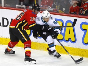 Calgary Flames, Michael Stone battles San Jose Sharks, Kevin Labanc in third period action of at the Scotiabank Saddledome in Calgary on Tuesday, February 4, 2020.