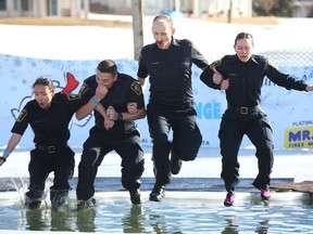 Calgary Peace Officers participate in the Polar Plunge "Freezin for a Reason" to raise funds for Special Olympics at Arbour Lake in northwest Calgary Saturday, February 22, 2020.
