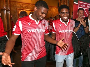 Cavalry FC players (L-R) Elijah Adekugbe, Bruno Zebie pose with new  Cavalry FC home kit during the team unveil ceremony for the CPL team in Calgary on Thursday, February 27, 2020. Jim Wells/Postmedia