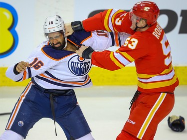 Edmonton Oilers Jujhar Khaira fights Buddy Robinson of the Calgary Flames during NHL hockey in Calgary on Saturday February 1, 2020.