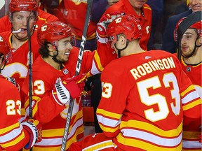 Calgary Flames Buddy Robinson celebrates with teammate Johnny Gaudreau after scoring a goal against the Edmonton Oilers during NHL hockey in Calgary on Saturday February 1, 2020.