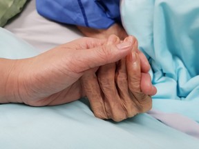 Holding grandmother's hand in the nursing care. Showing all love, empathy, helping and encouragement : healthcare in end of life and palliative concept