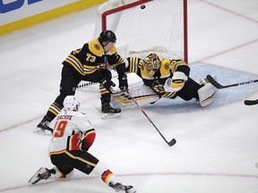 Calgary Flames Matthew Tkachuk puts a backhand past Boston Bruins goaltender Tuukka Rask on Tuesday, Feb. 25, in Boston.