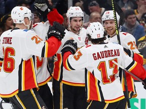 Flames Sean Monahan (centre) celebrates his goal against the Boston Bruins in the second period at TD Garden on Feb. 25, 2020.