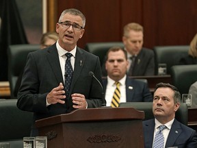 Travis Toews (Alberta Minister of Finance and President of the Treasury Board) delivers his provincial budget speech at the Alberta Legislature in Edmonton on Thursday February 27, 2020, as Alberta Premier Jason Kenney (right) looks on. (PHOTO BY LARRY WONG/POSTMEDIA)