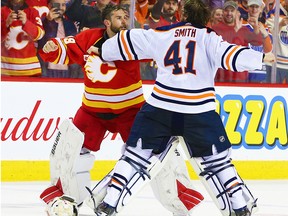 Calgary Flames goalie Cam Talbot and Edmonton Oilers goalie Mike Smith fight during NHL action in Calgary on Saturday, February 1, 2020.