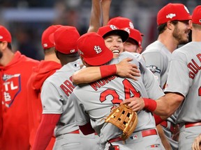 Cardinals third baseman Tommy Edman (facing camera) and third baseman Yairo Munoz (34) celebrate after defeating the Braves in Game 5 of the 2019 NL Divisional Series at SunTrust Park in Atlanta, on Oct. 9, 2019.