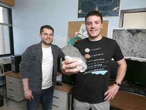 Research assistant Lincoln Hanton (L) and Fabio CIceri, PhD student in Planetary Science and Teaching assistant, pose with a meteorite sample at their University of Calgary offices on {ipcdow}, February 12, 2020. The sample is from the Buzzard Coulee Meteorite found in Saskatchewan in 2008. Reasearchers are investating the recent fireball over Calgary. Jim Wells/Postmedia