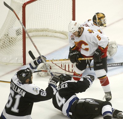 Calgary Flames goaltender Miikka Kiprusoff looks up at the replay following  a goal by Tampa Bay Lightning Brad Richards during first period of game  four of the NHL Stanley Cup Finals Monday