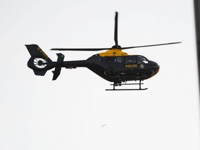 A police helicopter flies above London Bridge in London on Nov. 29, 2019, after reports of shots being fired on London Bridge.