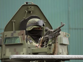 A member of the National Guard stands guard at a military check point outside the town of Uruapan in Michoacan state, Mexico February 5, 2020. REUTERS/Alan Ortega