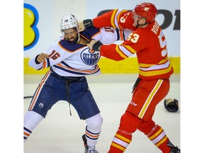 Edmonton Oilers Jujhar Khaira fights Buddy Robinson of the Calgary Flames during NHL hockey in Calgary on Saturday February 1, 2020. Al Charest / Postmedia