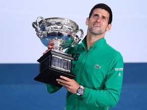 Novak Djokovic poses with the Norman Brookes Challenge Cup after winning the Men's Singles Final against Dominic Thiem at the Australian Open at Melbourne Park in Melbourne, Australia, on Sunday, Feb. 2, 2020.