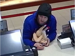 RCMP in Airdrie are looking for this man accused of stealing a donation box after covering it up with a rubber chicken.