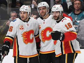 Calgary Flames Zac Rinaldo #36, TJ Brodie #7 and Tobias Rieder #16 celebrate after Rieder's goal against the San Jose Sharks in the first period at SAP Center on Feb. 10, 2020 in San Jose.