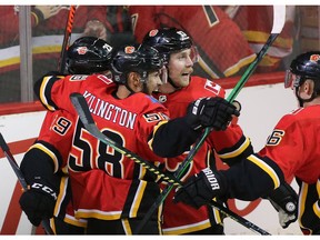 The Calgary Flames celebrate Sam Bennett's first goal on Chicago Blackhawks goalie Robin Lehner during NHL action in Calgary on Saturday, February 15. Photo by  Gavin Young/Postmedia.