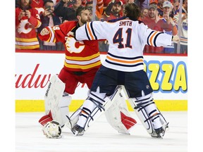 Calgary Flames goalie Cam Talbot and Edmonton Oilers goalie Mike Smith fight during NHL action in Calgary on Saturday. Photo by   Gavin Young/Postmedia.