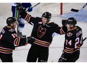 The Calgary Hitmen's Carson Focht, centre, celebrates with Josh Prokop and Luke Coleman after a goal on the Swift Currents during the TELUS BE BRAVE Anti-Bullying Game at the Scotiabank Saddledome on Wednesday February 27, 2019. Gavin Young/Postmedia ORG XMIT: POS1902271434350885