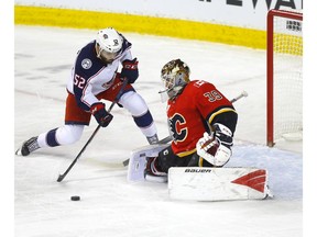 Calgary Flames goalie Cam Talbot battles Columbus Blue Jackets Emil Bemstrom in first period NHL action at the Scotiabank Saddledome in Calgary on Wednesday, March 4, 2020. Darren Makowichuk/Postmedia