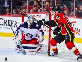 Mar 4, 2020; Calgary, Alberta, CAN; Calgary Flames left wing Andrew Mangiapane (88) controls the puck in front of Columbus Blue Jackets goaltender Joonas Korpisalo (70) during the third period at Scotiabank Saddledome. Mandatory Credit: Sergei Belski-USA TODAY Sports ORG XMIT: USATSI-406023