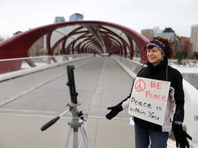 Calgary Peace Walk organizer Tina Thrussell live streams from the Peace Bridge as she encourages supporters to walk in their neighbours after this year's walk was cancelled due to COVID-19 precautions on Saturday, March 28, 2020. Gavin Young/Postmedia