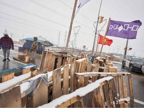 In this file photo taken on February 26, 2020 First Nations protestors man a barricade on Highway 6 near Caledonia, Ontario which the protestors set up in support of the Wet'suwet'en hereditary chiefs and the Tyendinaga Mohawks.